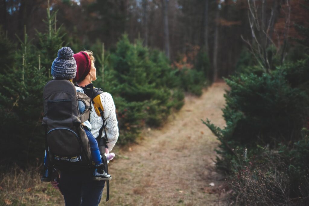 Mom and kid hiking through a trail