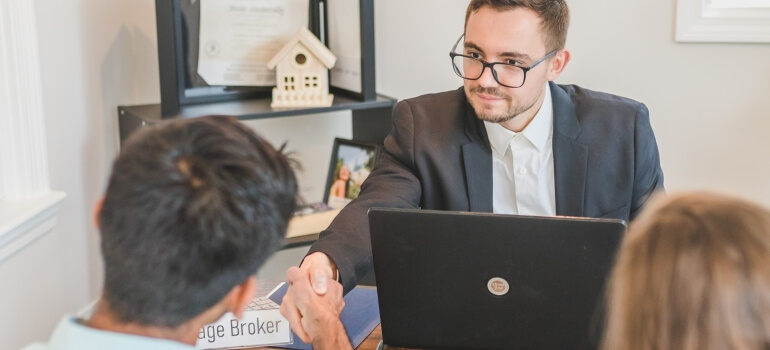 A mortgage broker shaking hands with a client