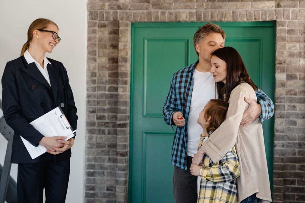 A happy couple with a child made a deal with a real estate agent