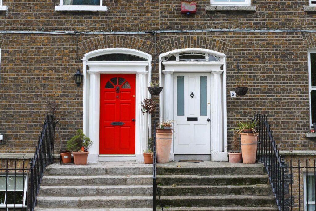 brick townhomes with red and white doors